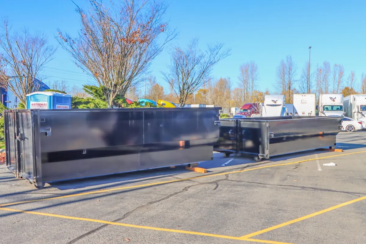 Professional dumpster rental service with roll-off container on residential driveway in Vernal